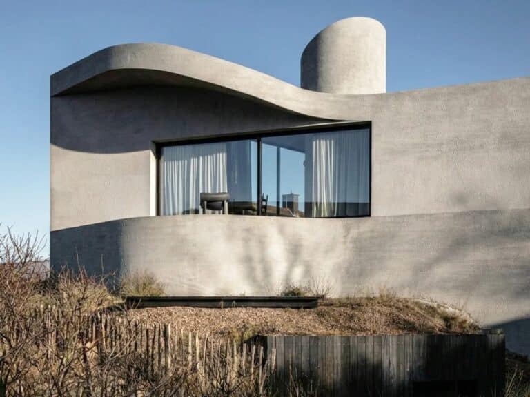Side view of Villa Nouvelle Vague showing the curved concrete roofline mimicking tide recession marks on sand.