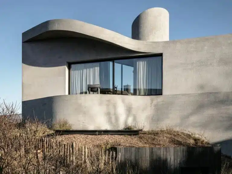 Side view of Villa Nouvelle Vague showing the curved concrete roofline mimicking tide recession marks on sand.