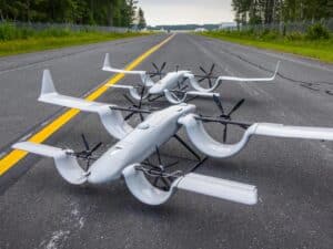 Two grey HopFlyt Cyclone UAV prototypes featuring Custer Channel Wings parked on an asphalt runway.