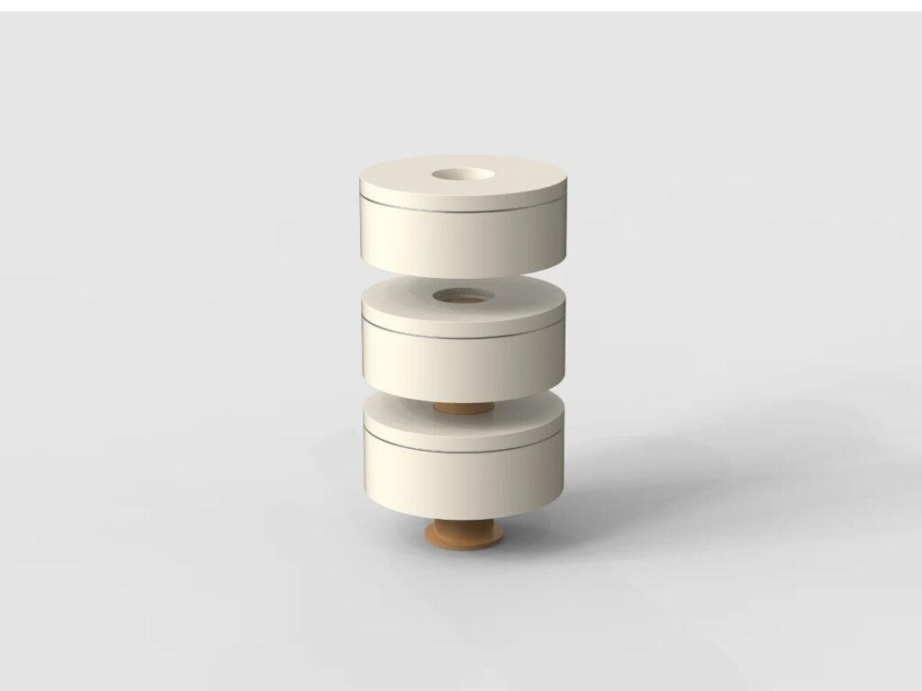 Exploded isometric view of three ring containers being assembled onto a central orange cylinder.