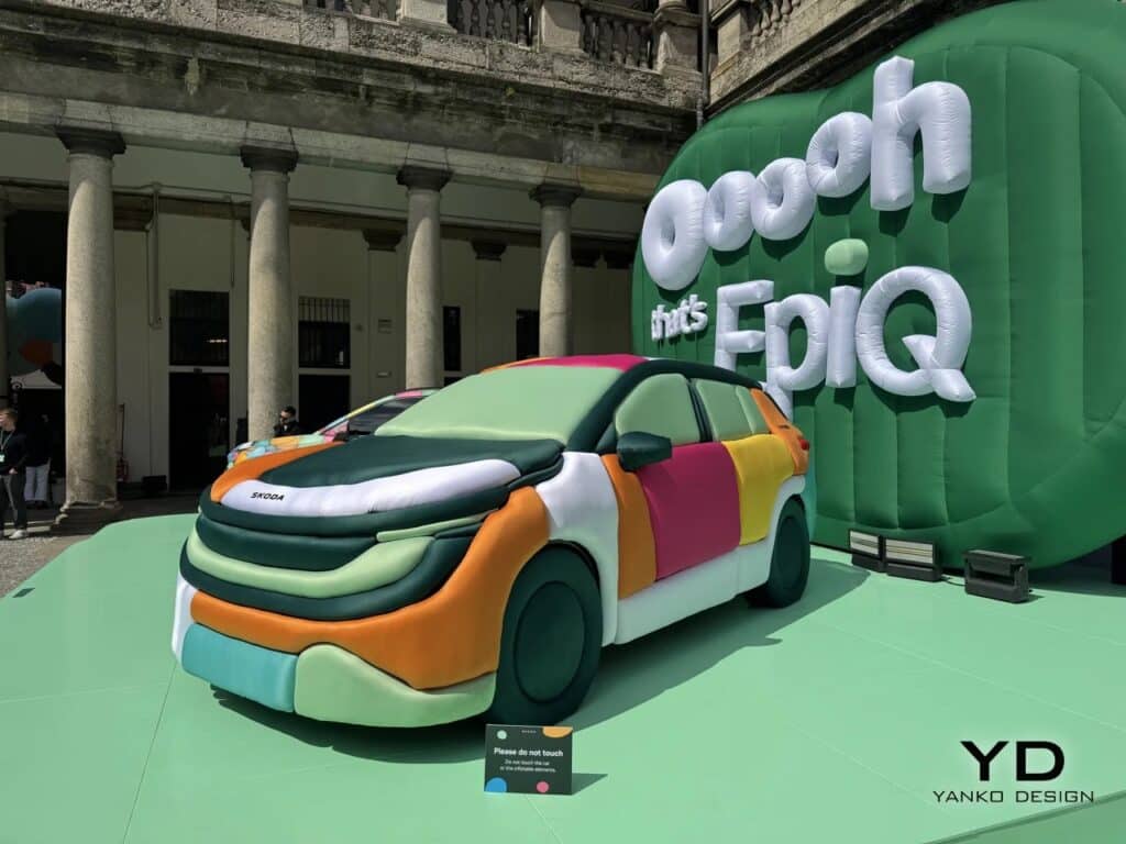 Side front view of the inflatable Skoda Epiq car in an architectural courtyard with classical columns.