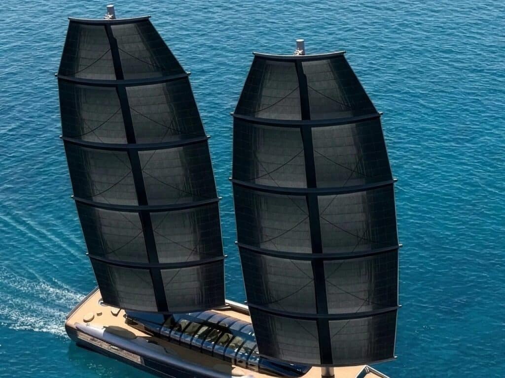 Close-up of the dual DynaRig masts on the A100 yacht, showing the curved yards and black high-performance sails.