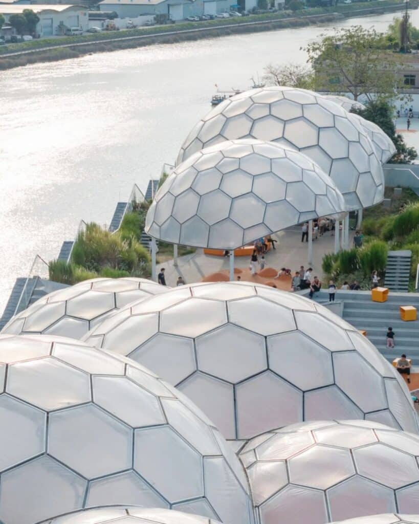 Sequence of translucent hexagonal domes along the Huadi River at the Yongping Warehouse rooftop.