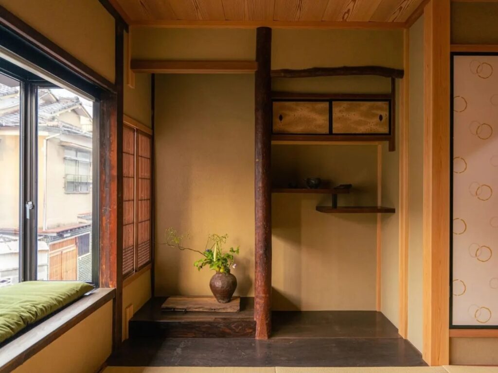 Traditional Japanese room corner at Genji Kyoto with Tokonoma alcove and seasonal flowers.