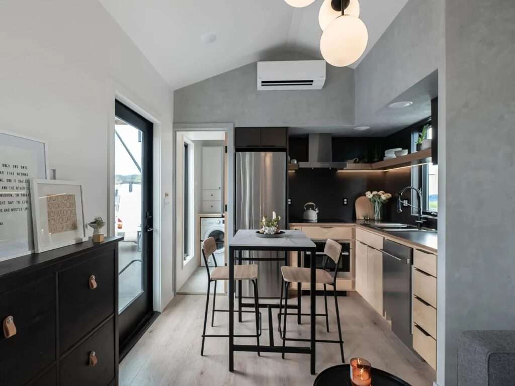 Contemporary kitchen in Urban Gable Park featuring maple cabinets, stainless steel appliances, and a dining island.