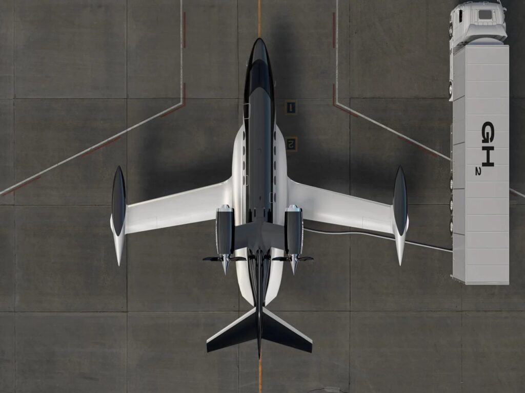 Top-down view of the BYA-I One aircraft on an airport apron being refueled by a Gaseous Hydrogen (GH2) truck.