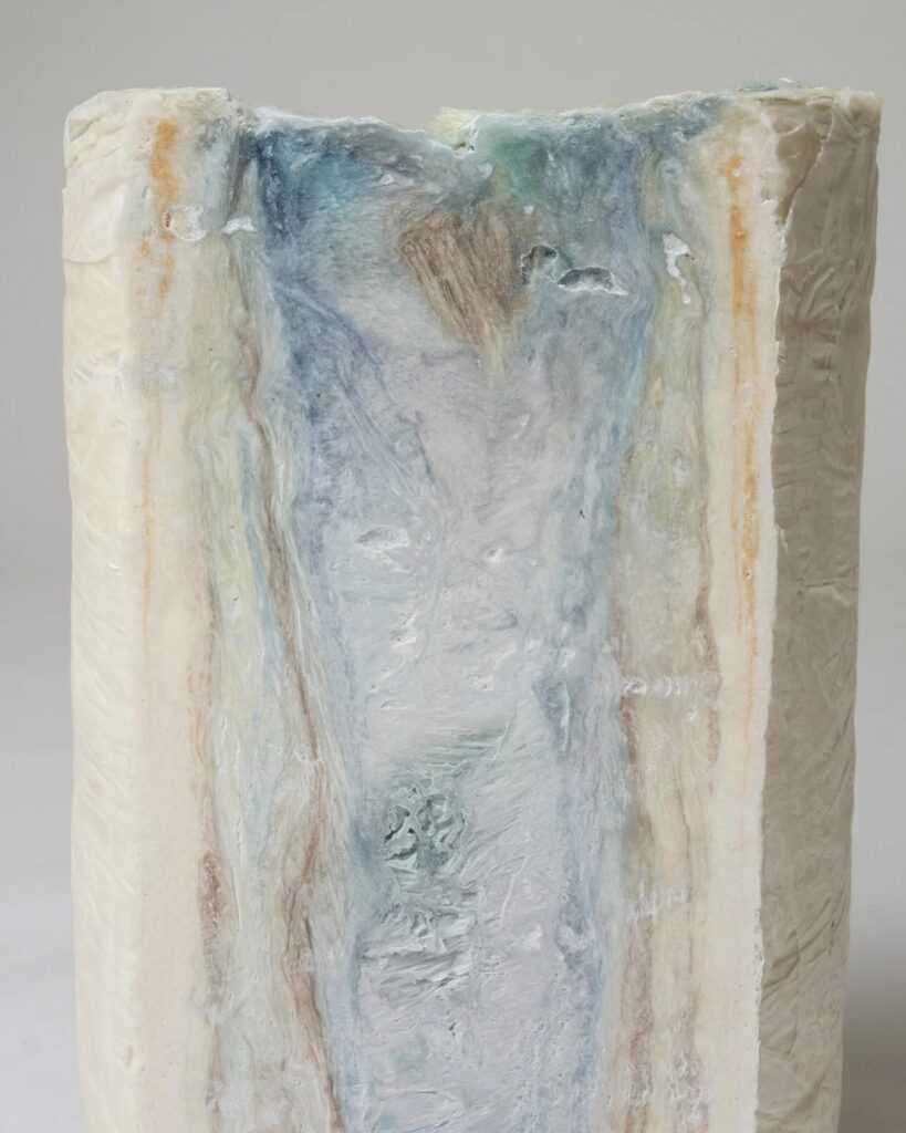 Macro photography of compressed paper fibers showing blue and brown tonal variations.