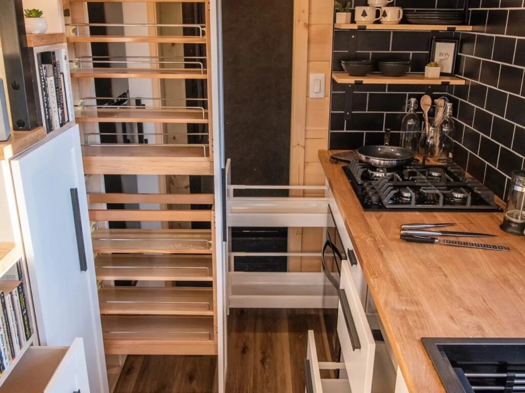 Integrated pull-out pantry and storage drawers in the Scandi Inn kitchen.
