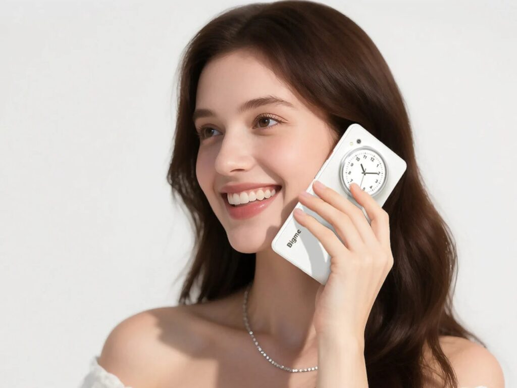 A woman smiling while holding the Bigme HiBreak Dual to her ear during a call, showing the rear design.
