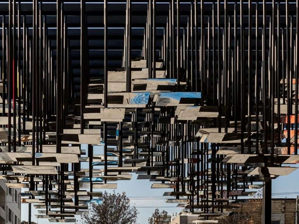 Close-up detail of the 3D undulating ceiling featuring hundreds of small suspended mirror pieces.