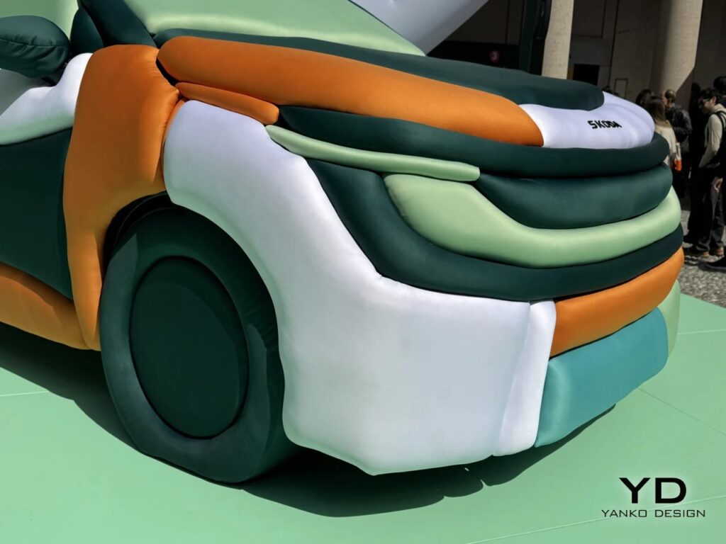 Extreme close-up of the front wheel and bumper area of the Skoda Epiq inflatable installation.