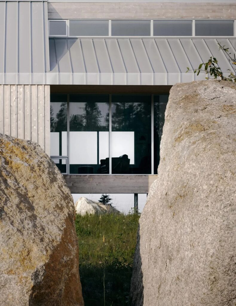 Abstract architectural shot of East River Residence framed between two large granite rocks.