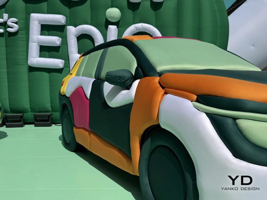 Front three-quarter detail of the Skoda Epiq with inflatable tubes in various green and orange shades.