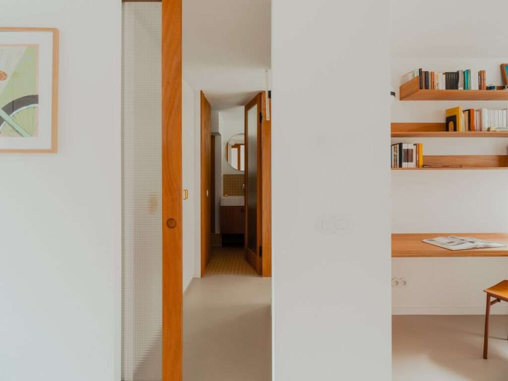 View of a stainless steel kitchen counter and a semi-circular frosted glass interior window.