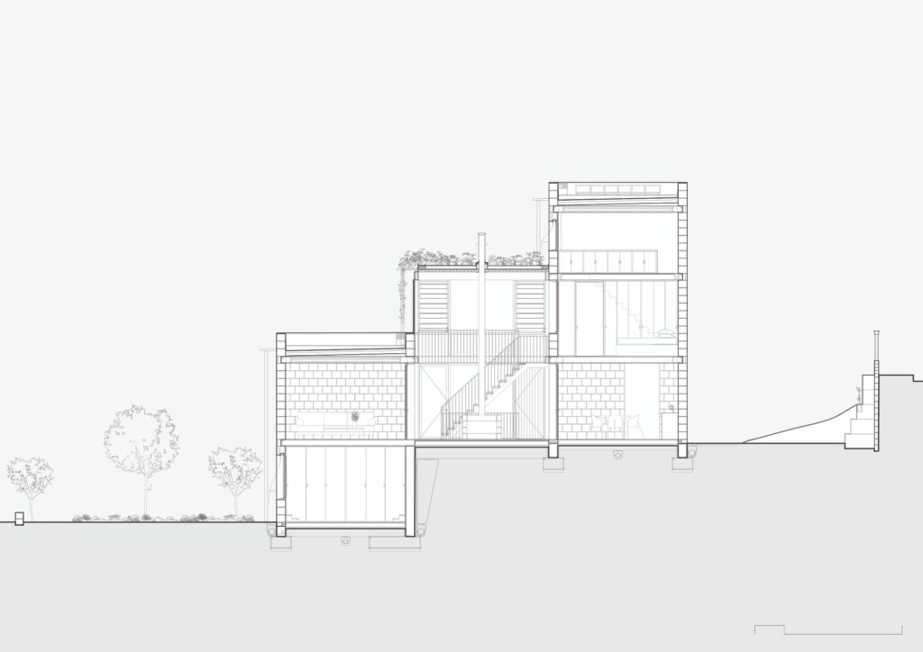 Architectural cross-section showing the stepped levels of the house following the natural slope of the ground.