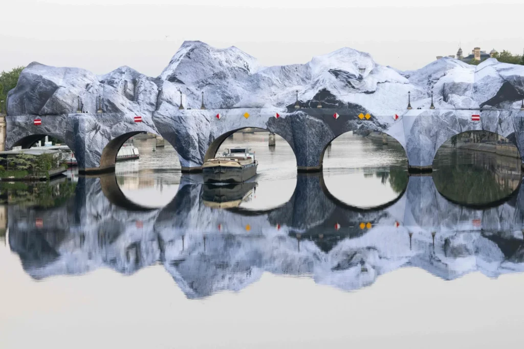 Pont Neuf Cave installation showing limestone-printed inflatable arches reflecting on the Seine with a passing barge