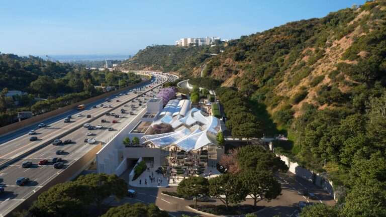 Aerial view of a modern tram station with a parametric glass canopy next to a multi-lane freeway.