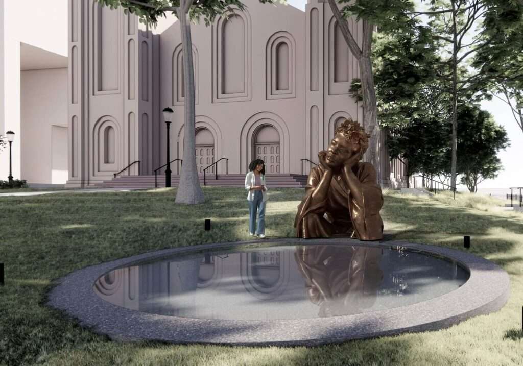 Large bronze sculpture of Billie Holiday with eyes closed, head resting on her hand and shoulders draped in flowing fabric, positioned beside a circular granite reflecting pool with a woman visitor standing nearby on a sloping lawn before a pale pink arched facade