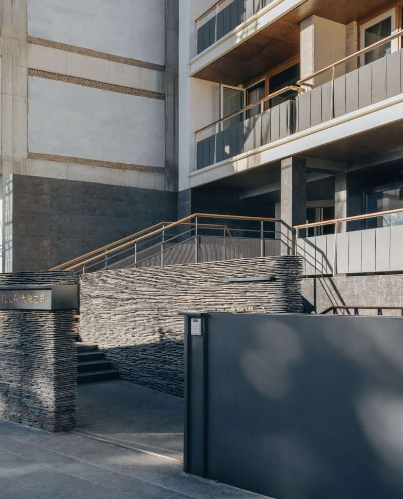 Minimalist entrance stairs and dark slate textured walls of the Kawagebo Snow Mountain Hotel.