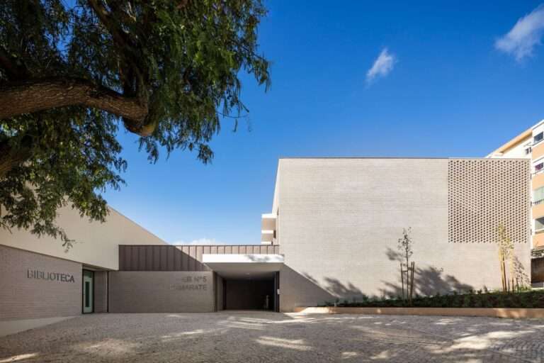 Main entrance of Basic School and Kindergarten No. 5 in Camarate with the public library wing and a new urban plaza.