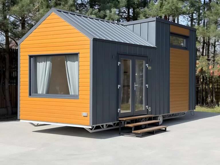 Exterior view of the Smile tiny house by Vagabond Haven featuring a combination of yellow wood cladding and dark grey metal panels.