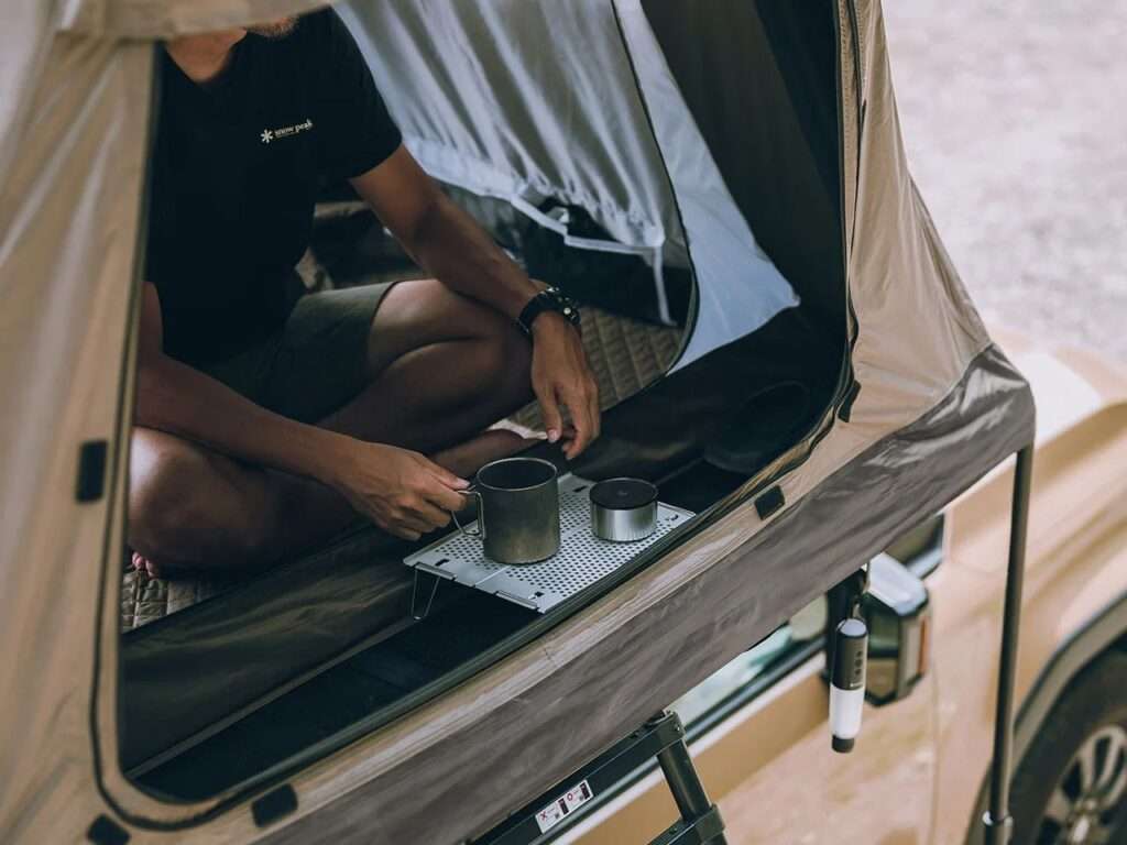 Interior perspective of the tent entrance showing a small utility tray, emphasizing the separation of indoor and outdoor zones.
