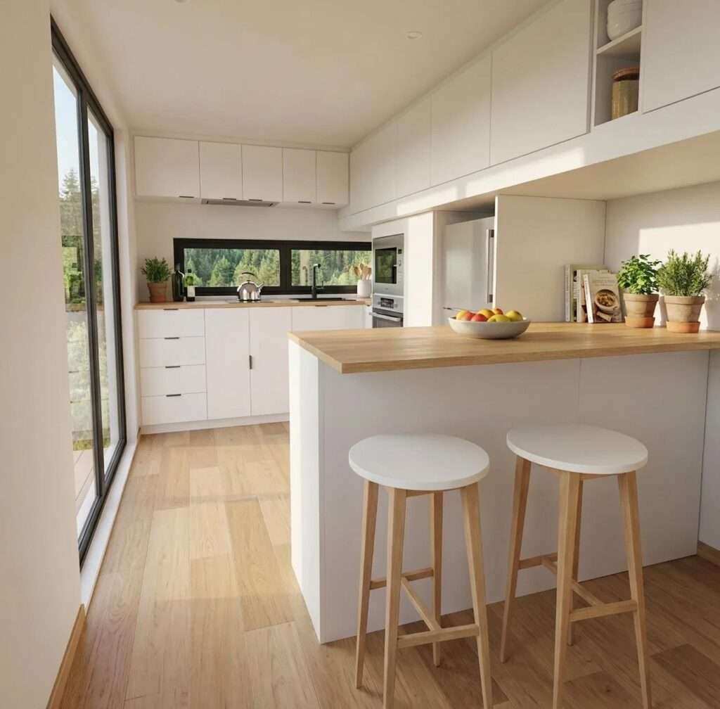 Bright white linear kitchen in a tiny house with wood countertops, integrated appliances, white upper cabinets, and a kitchen island with two wooden stools.