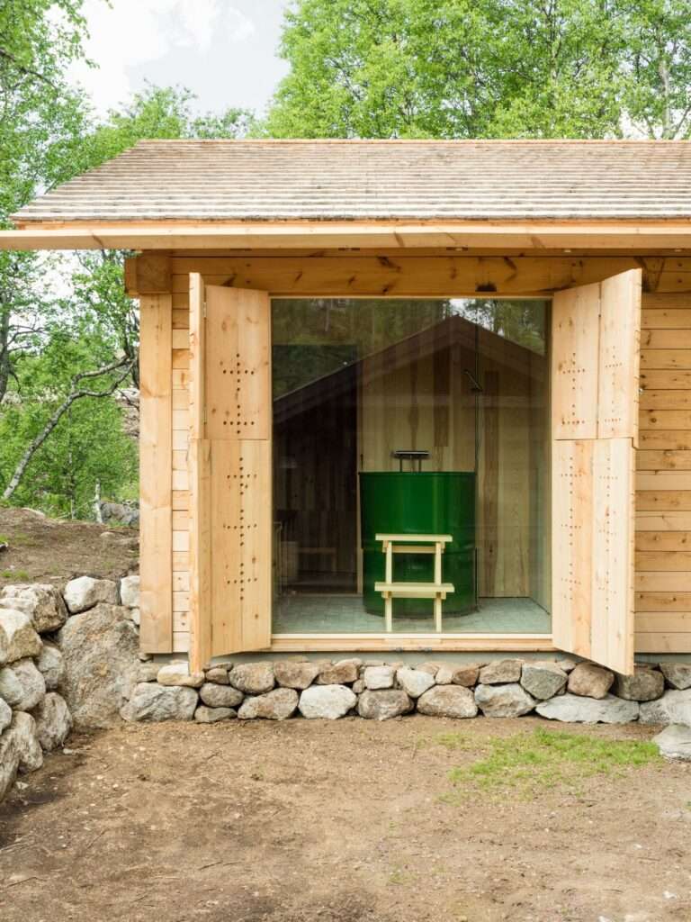Detail view of the Timber Temple sauna room featuring a deep green soaking tub inspired by local natural ponds.