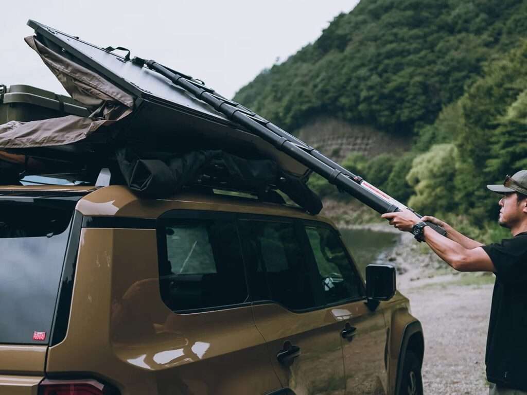 A user setting up the Fire Rise RTT by engaging the inflatable structural frame.