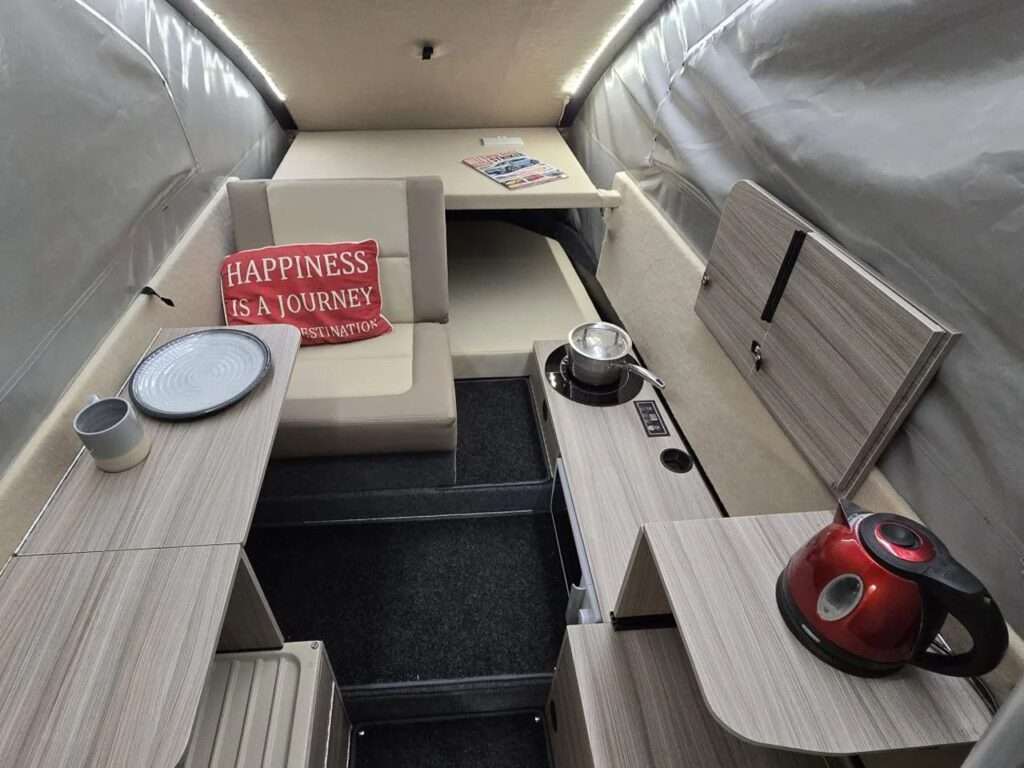 Wide-angle interior view of Dashaway ECT showing the seating area, table, and kitchen layout.