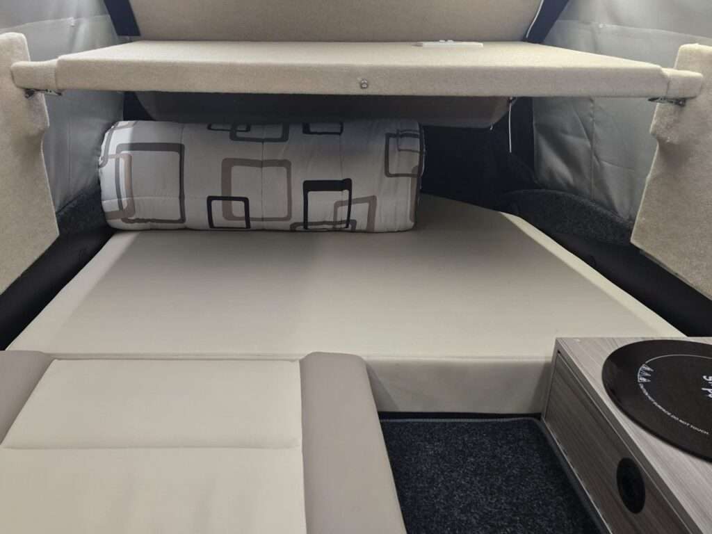 Interior of Dashaway ECT converted into a sleeping area with a flat mattress and bedding.