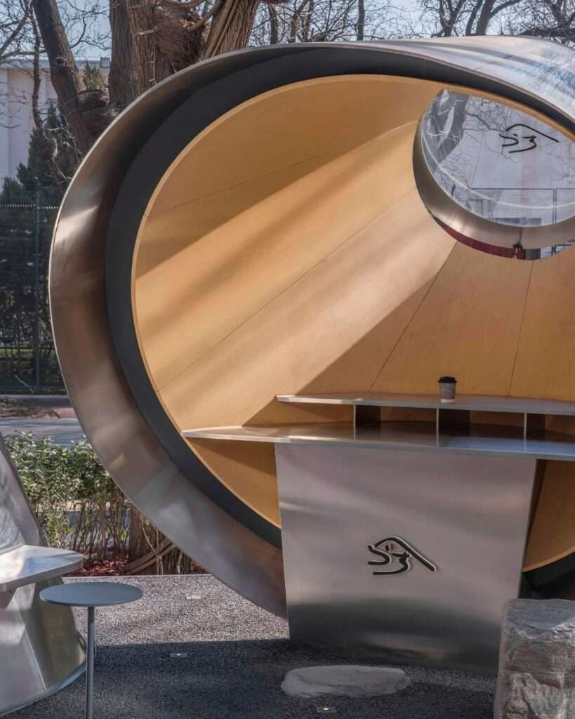 Detailed view of the outdoor interactive exhibition stand under the smaller steel shell of the Kurasu pavilion.