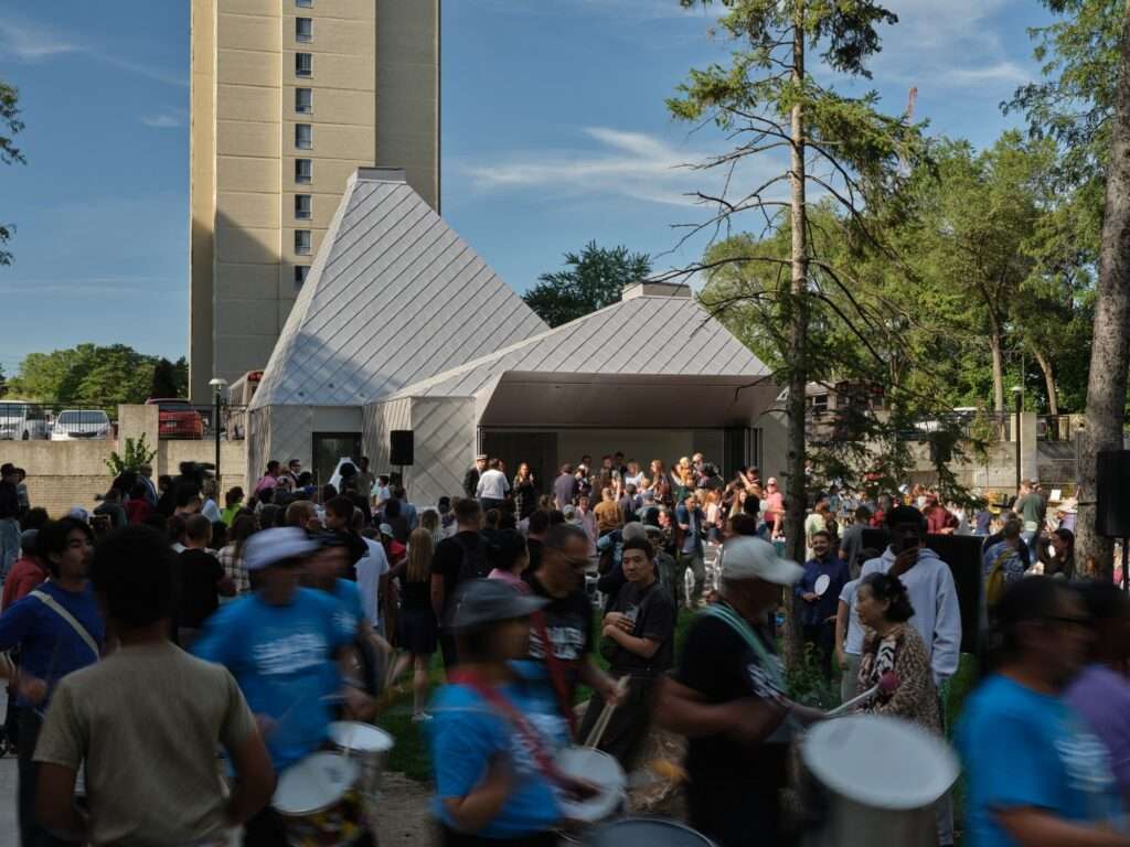 A large crowd of neighborhood residents gathered for an outdoor musical festival and celebration in front of the Mabelle Park pavilion.