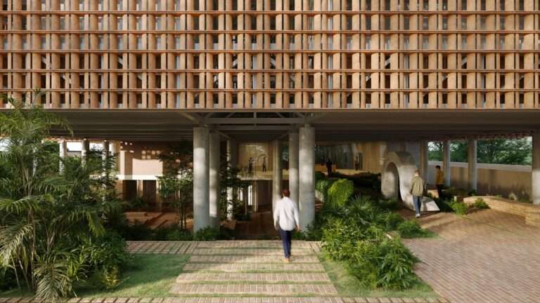 Pedestrian walking through a shaded plaza beneath an elevated building with a ceramic lattice screen facade.