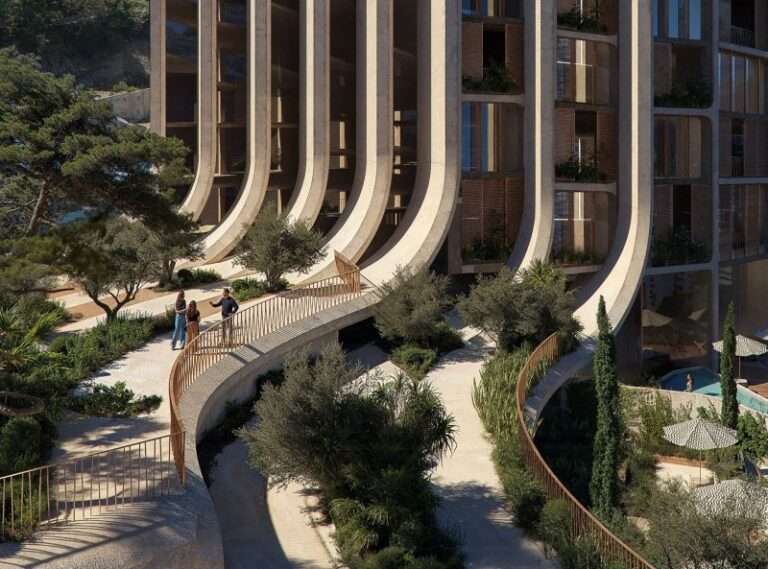 An exterior view of a building facade with curving concrete vertical elements and a pedestrian walkway.