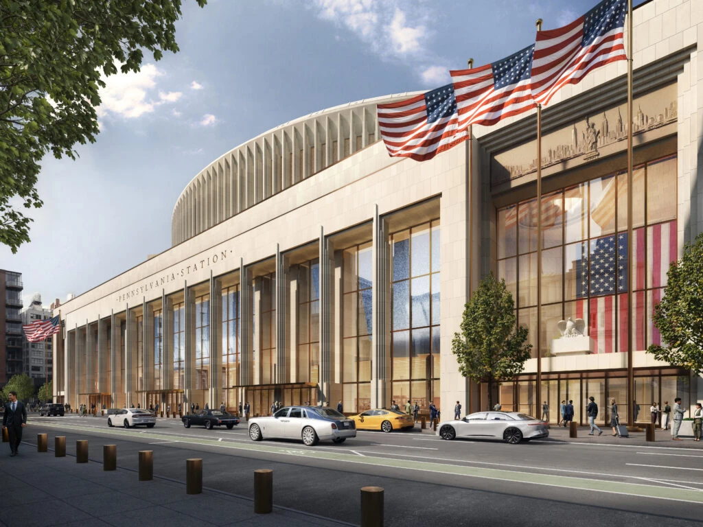Exterior view of the proposed Pennsylvania Station stone facade with tall glass windows and American flags.