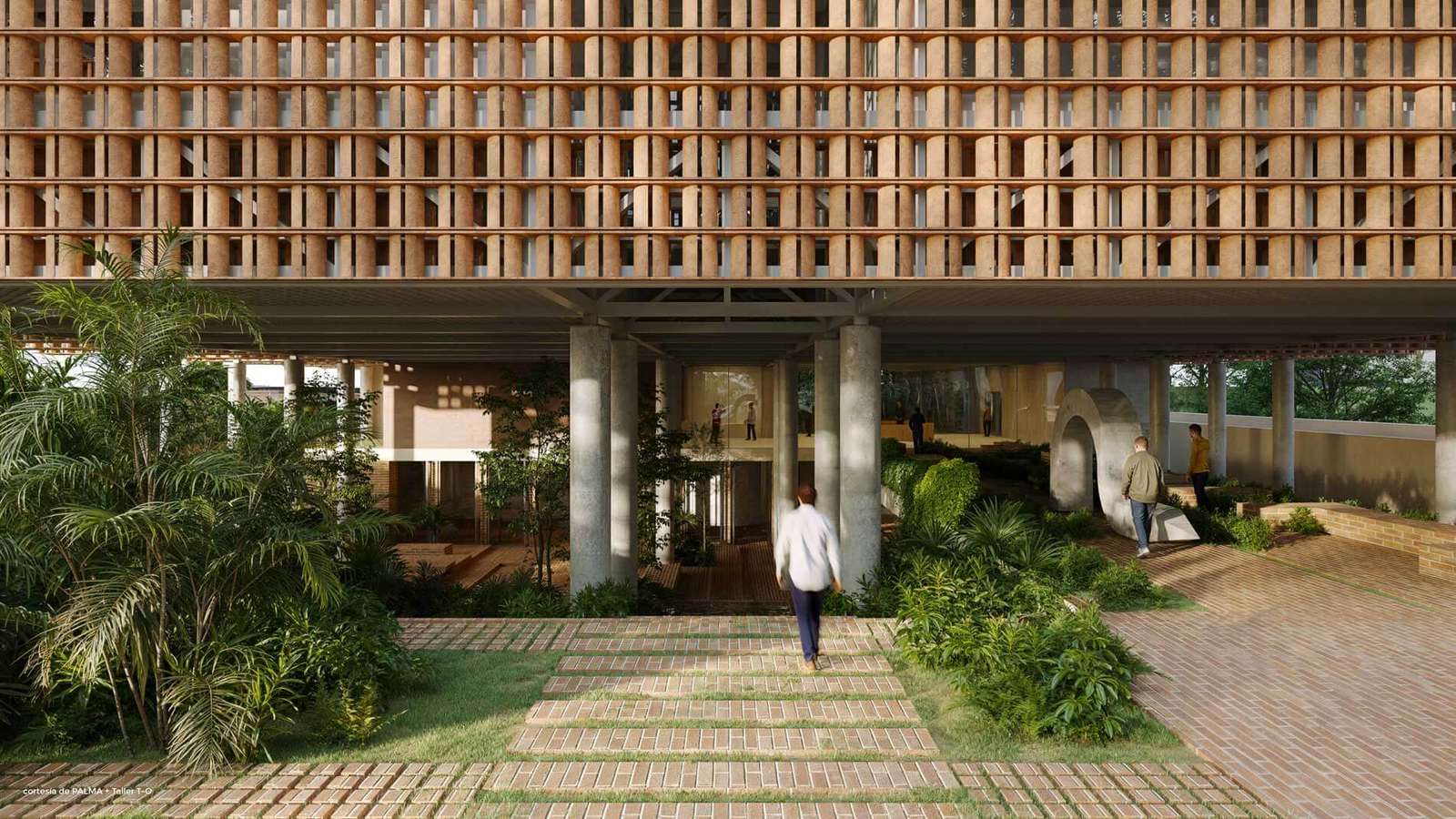A covered entrance plaza under a large building massing supported by thick columns with a brick paved pathway and native landscaping.