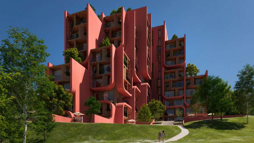 A group of modern residential buildings with deep red curved balconies next to a green lawn.