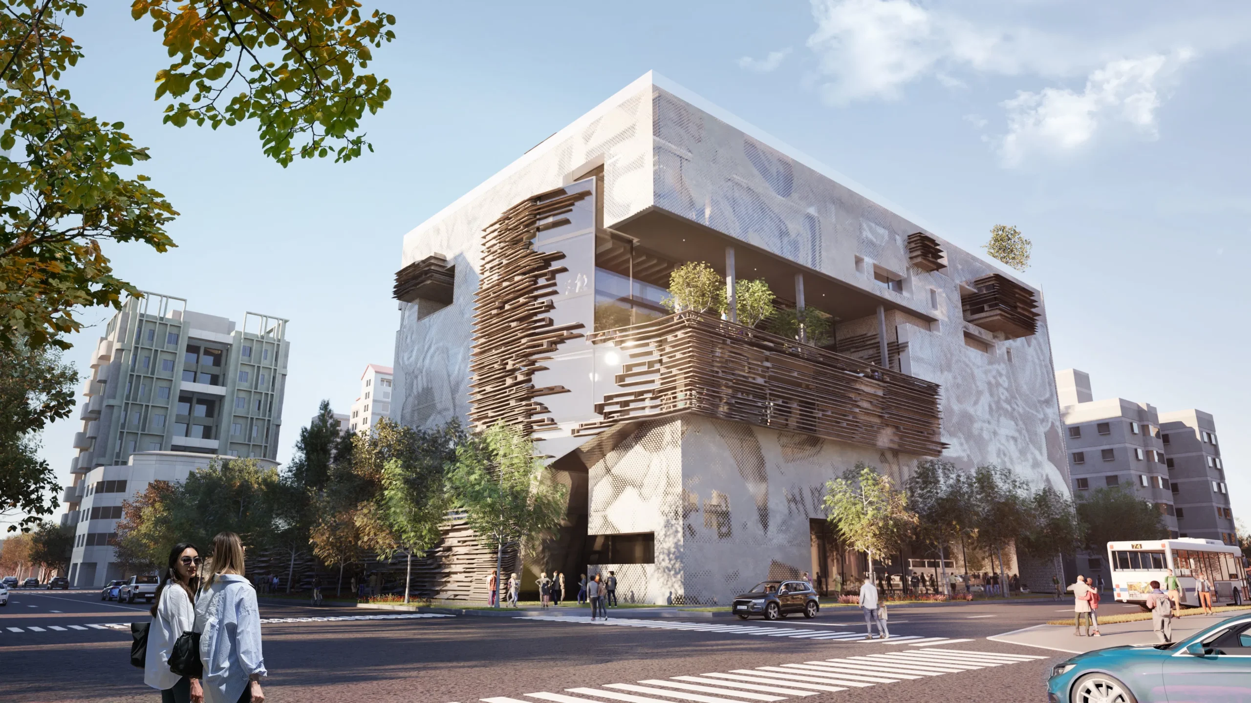 Street-level view of a contemporary cultural building with a graphic fritted glass facade and timber louver systems.