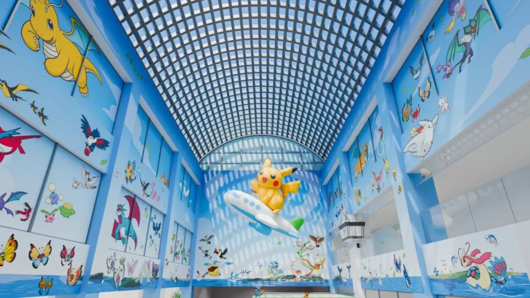 A large interior airport atrium featuring a suspended central sculpture and extensive graphic wall panels.