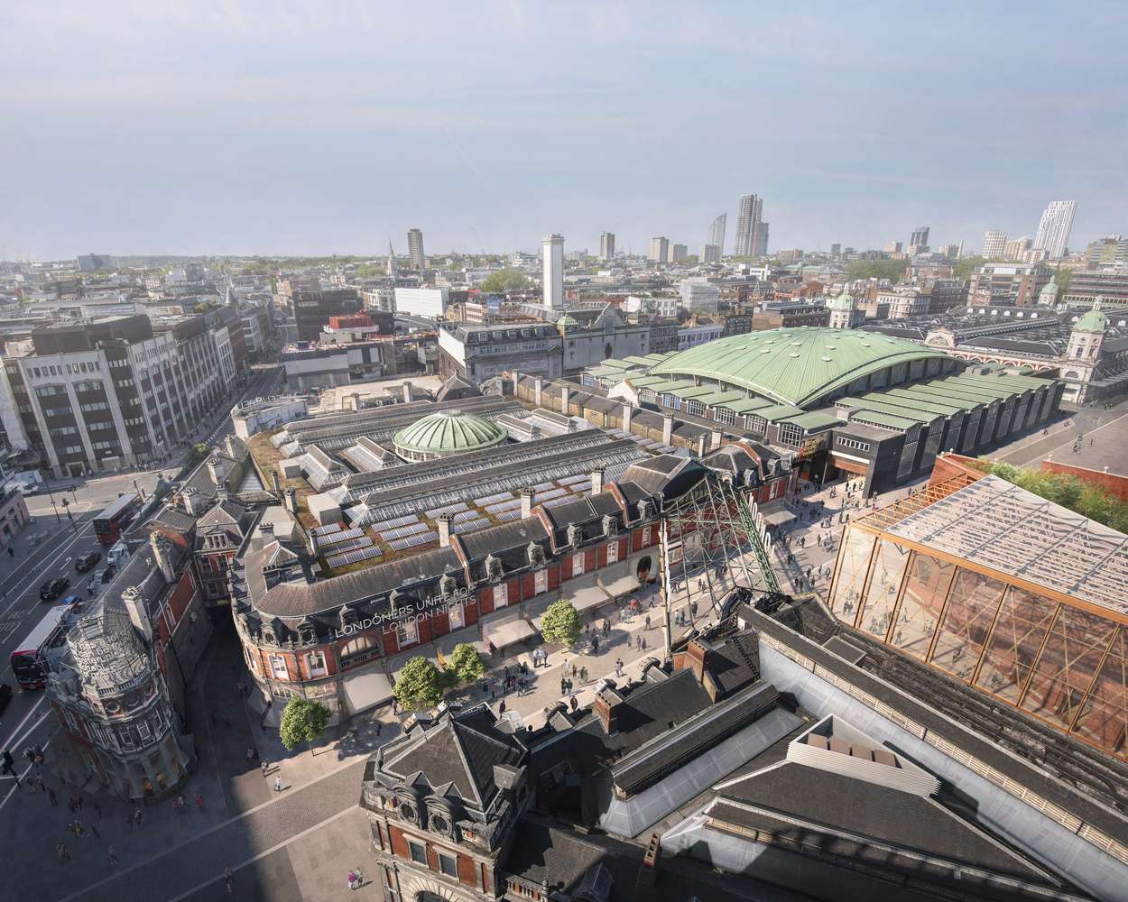 Aerial view of a large historic market building complex with a central dome integrated into a dense city context.