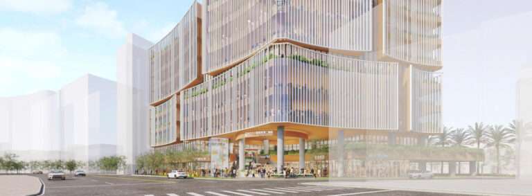 Street view of a multi-story civic building with curved facades, white vertical louvers, and a ground-level plaza.