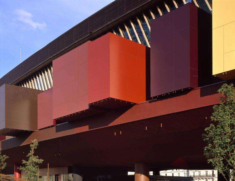 Close-up view of prominent colored rectangular facade modules cantilevered from the main building structure.