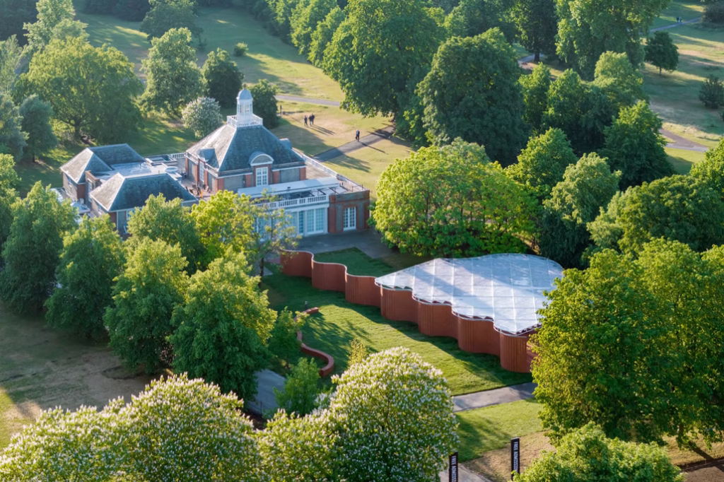 Elevated view showing the winding brick pavilion situated next to the historic Serpentine South Gallery.