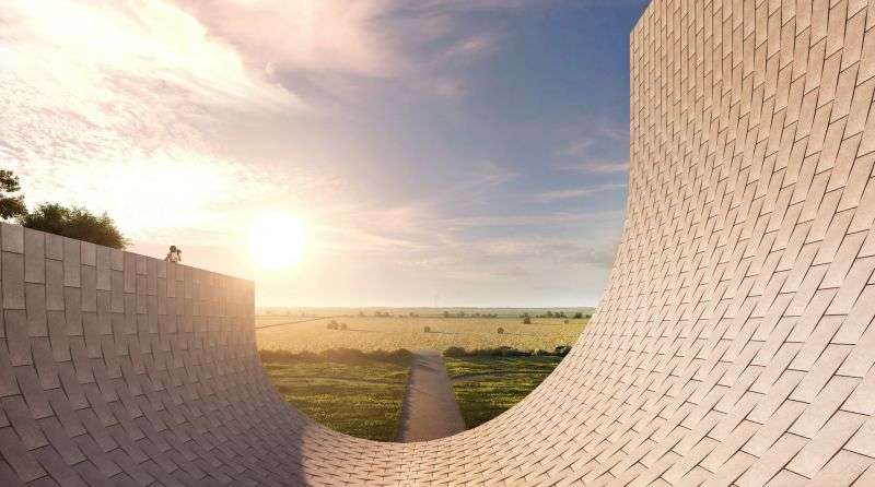 A close-up view of a curved white tiled wall facing an open agricultural field.