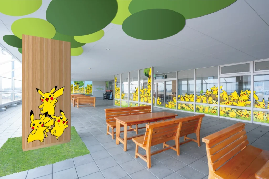 An indoor waiting lounge equipped with wooden benches and extensive glazing covered in decals.