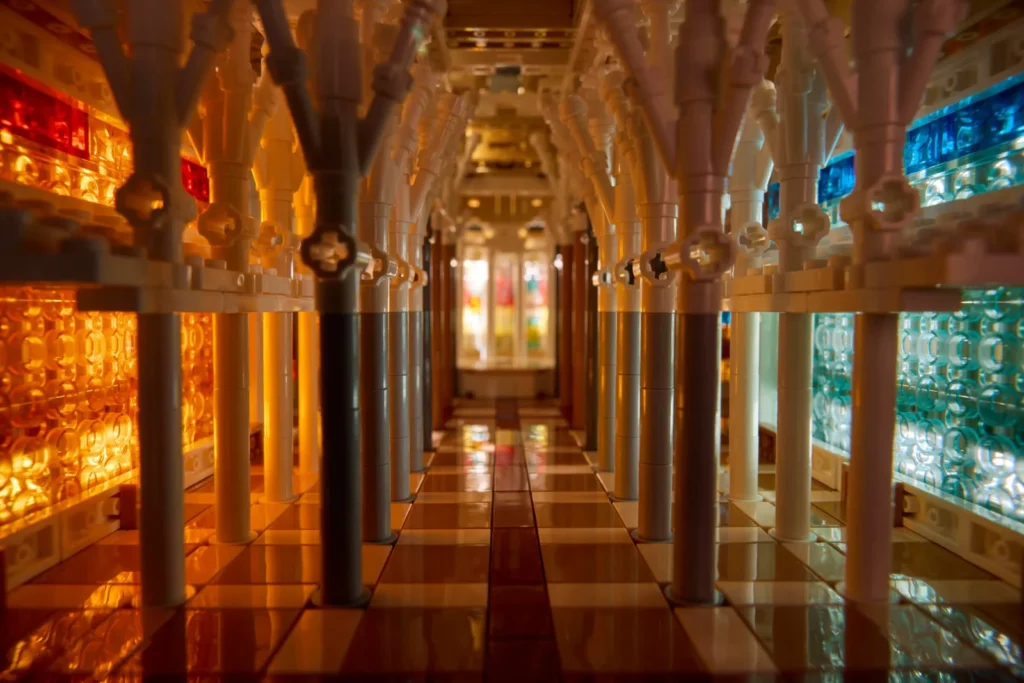 Symmetrical internal perspective of the LEGO basilica model with rows of branching white columns.