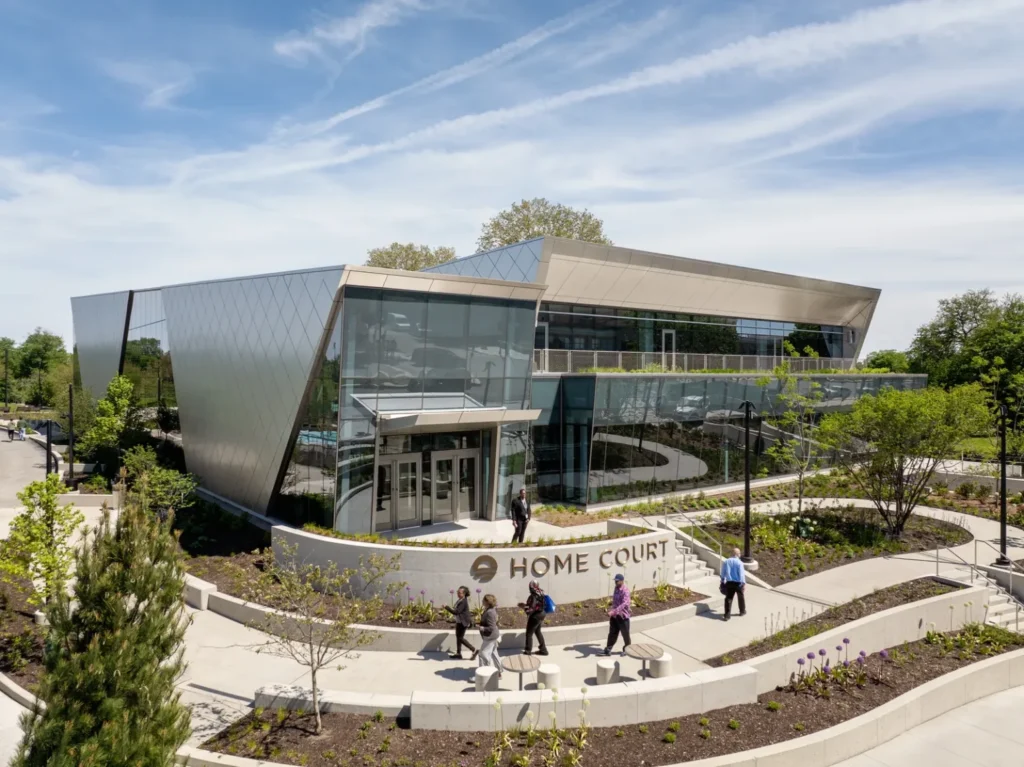 A modern low-rise building with a metallic diamond-patterned facade and glass storefront entry.