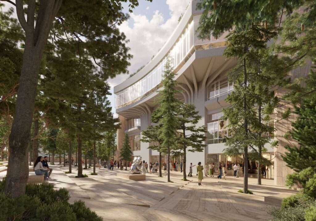 Exterior view of a curved building facade with branch-like columns next to a wooded path.
