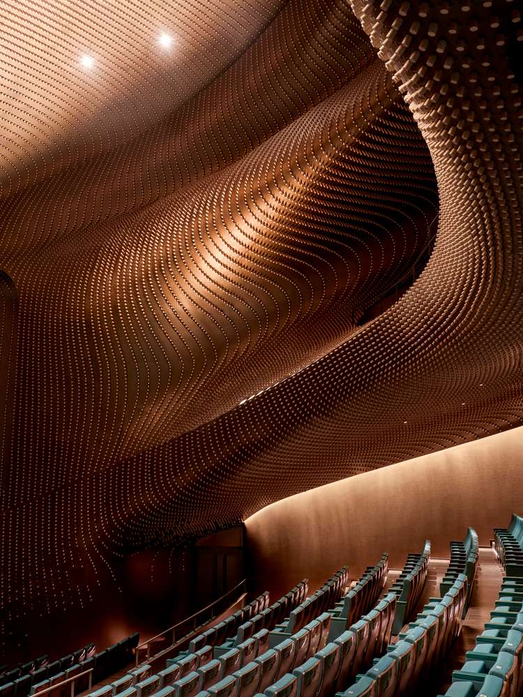 A close-up details of the sculptural, textured acoustic panels and spines on the theatre wall